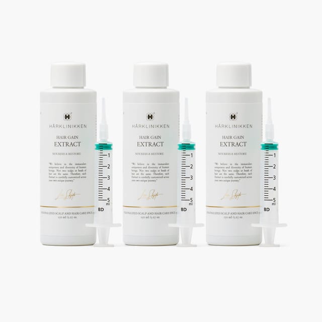 Three bottles of Hair Gain Extract with dosing syringes