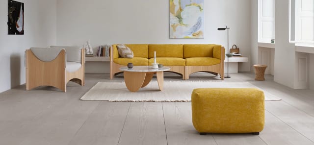 Bug three-seater in yellow with a grey chair, oak table and footstool