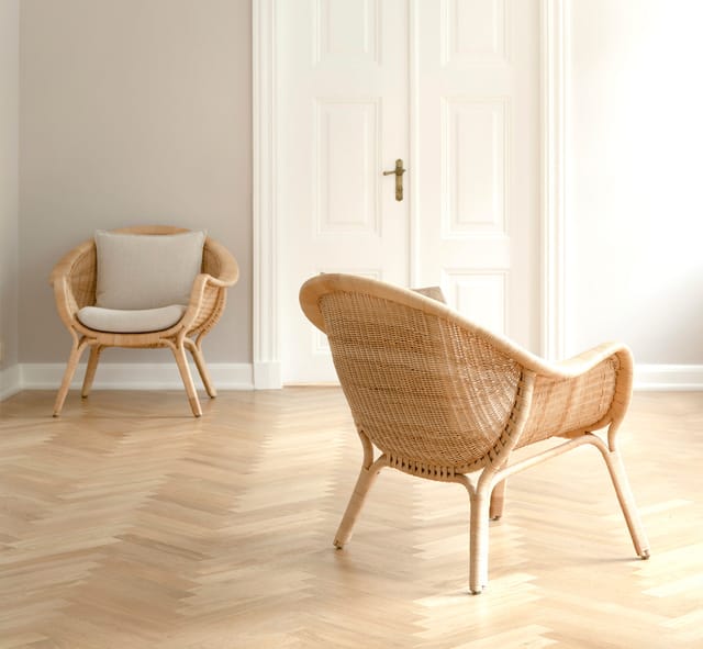 Two Madame Lounge Chairs in a room with a herringbone floor