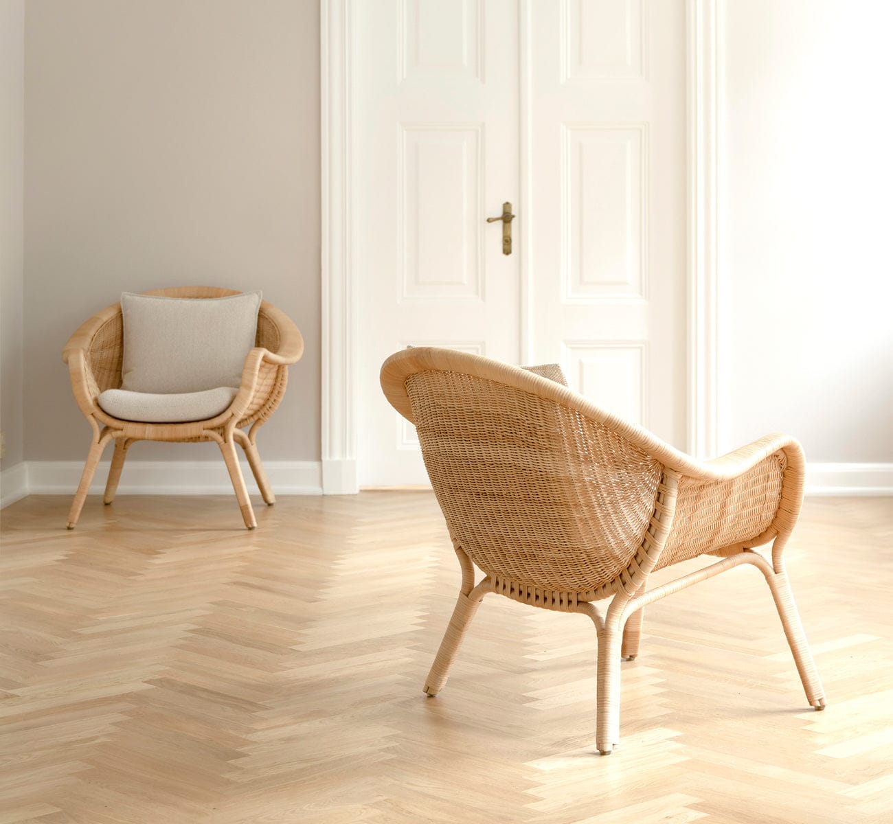 Two Madame Lounge Chairs in a room with a herringbone floor