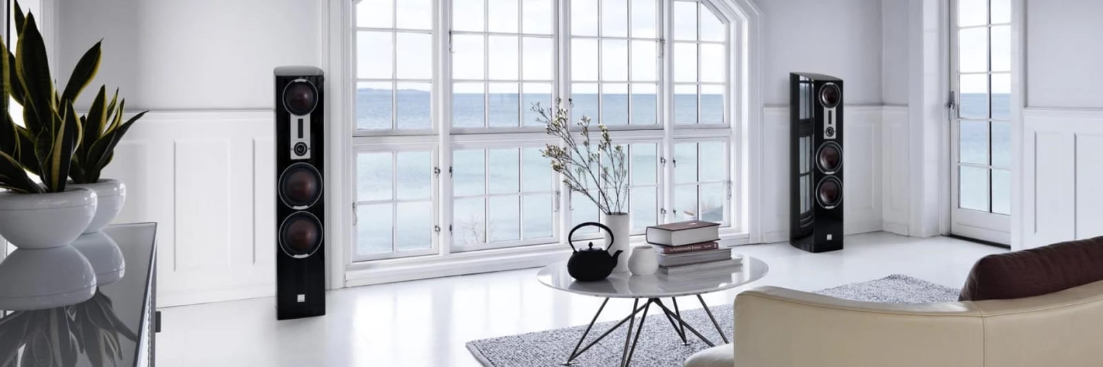 A pair of Epicon 8 speakers in a living room by the sea