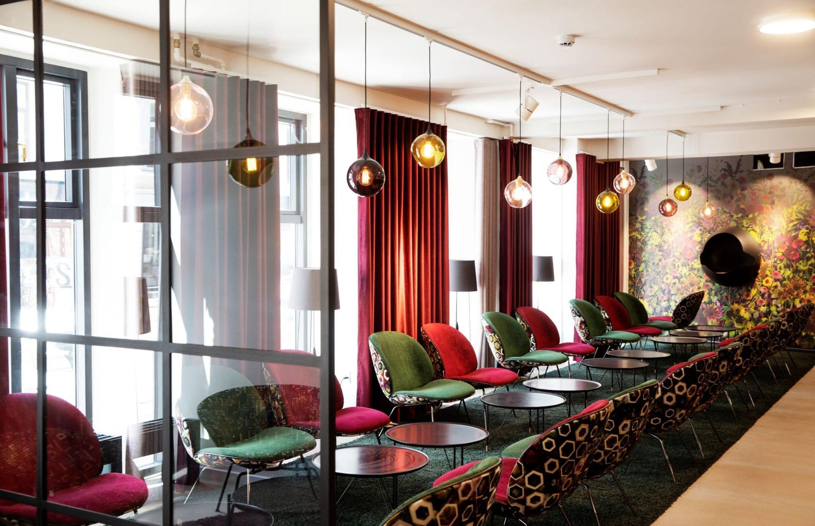 The lobby lounge with velvet curtains and glass pendants