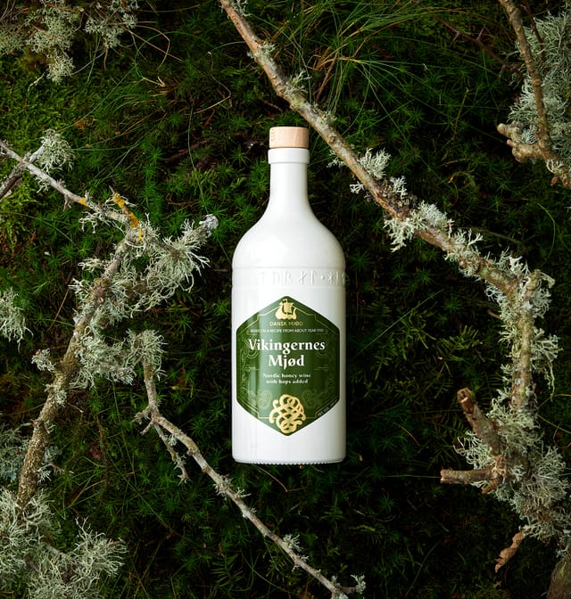 A bottle of Vikingernes Mjød on moss and lichen