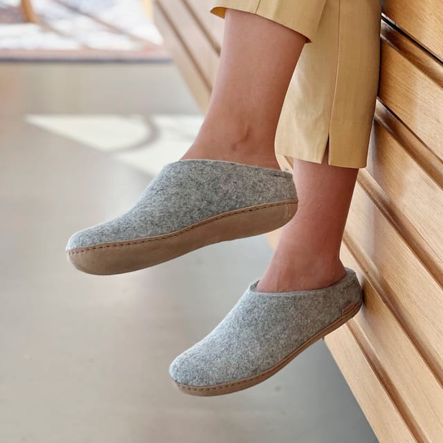 Grey slip-ons with calfskin soles, worn