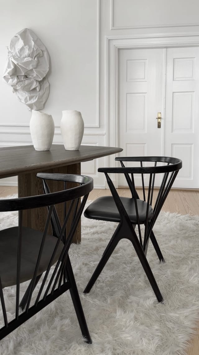Two black No 8 chairs at a dining table