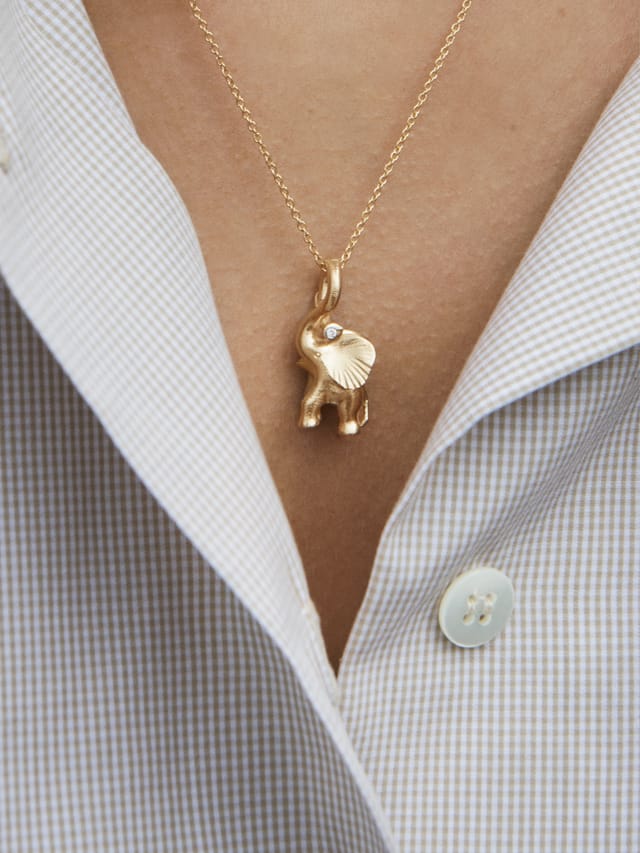 Gold elephant pendant on a chain