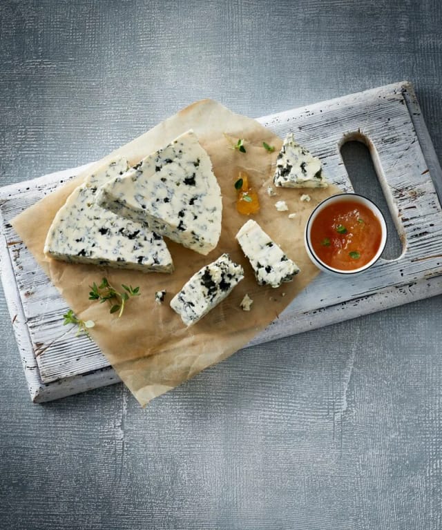 Wedges of Castello Danish Blue on a board