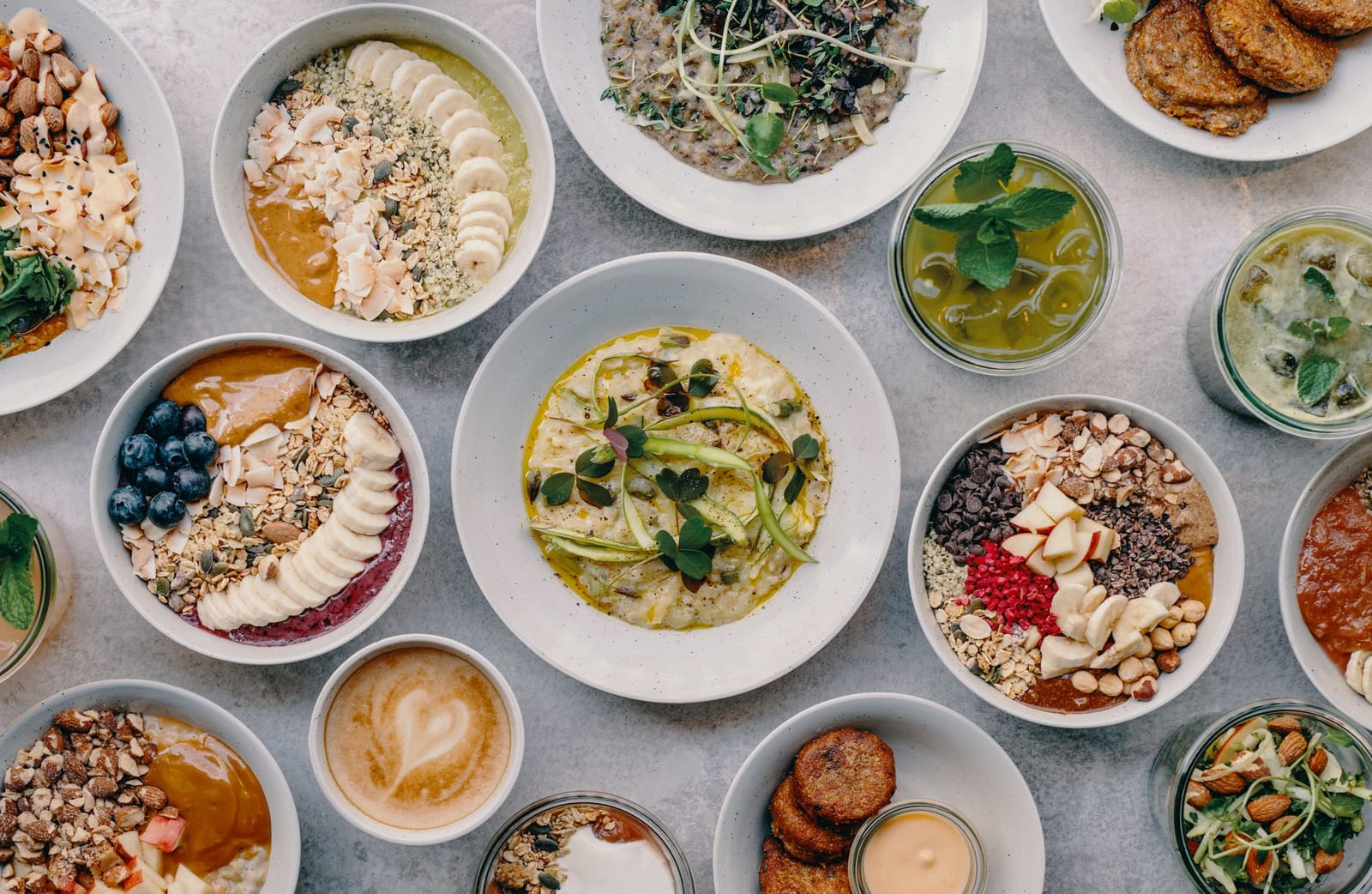 Bowls of porridge, risotto and patties on a table