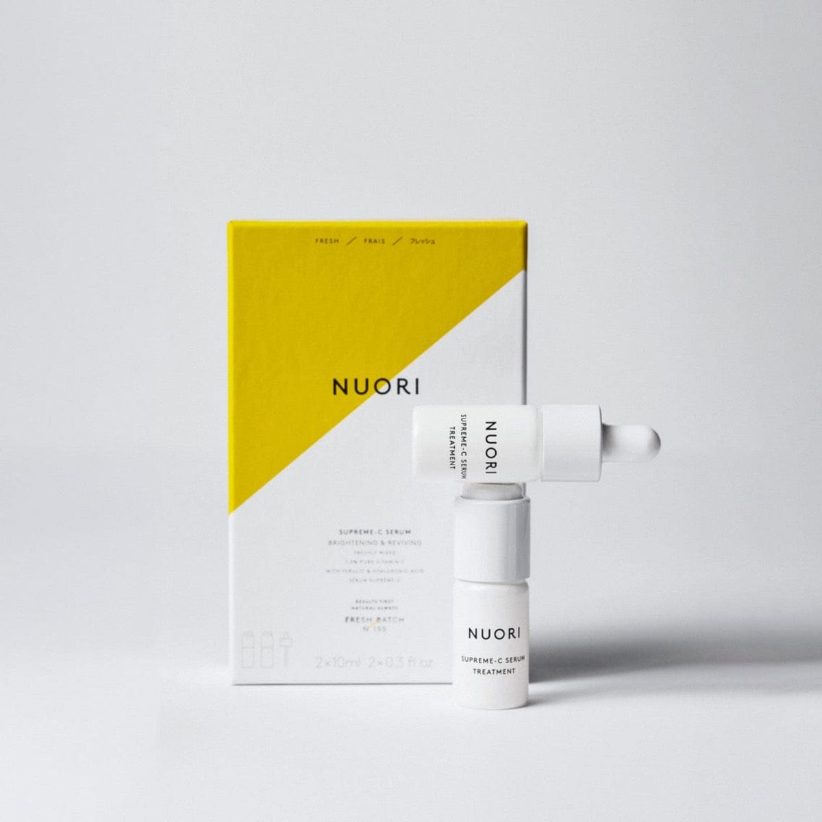 Supreme-C Serum vials in front of their yellow box
