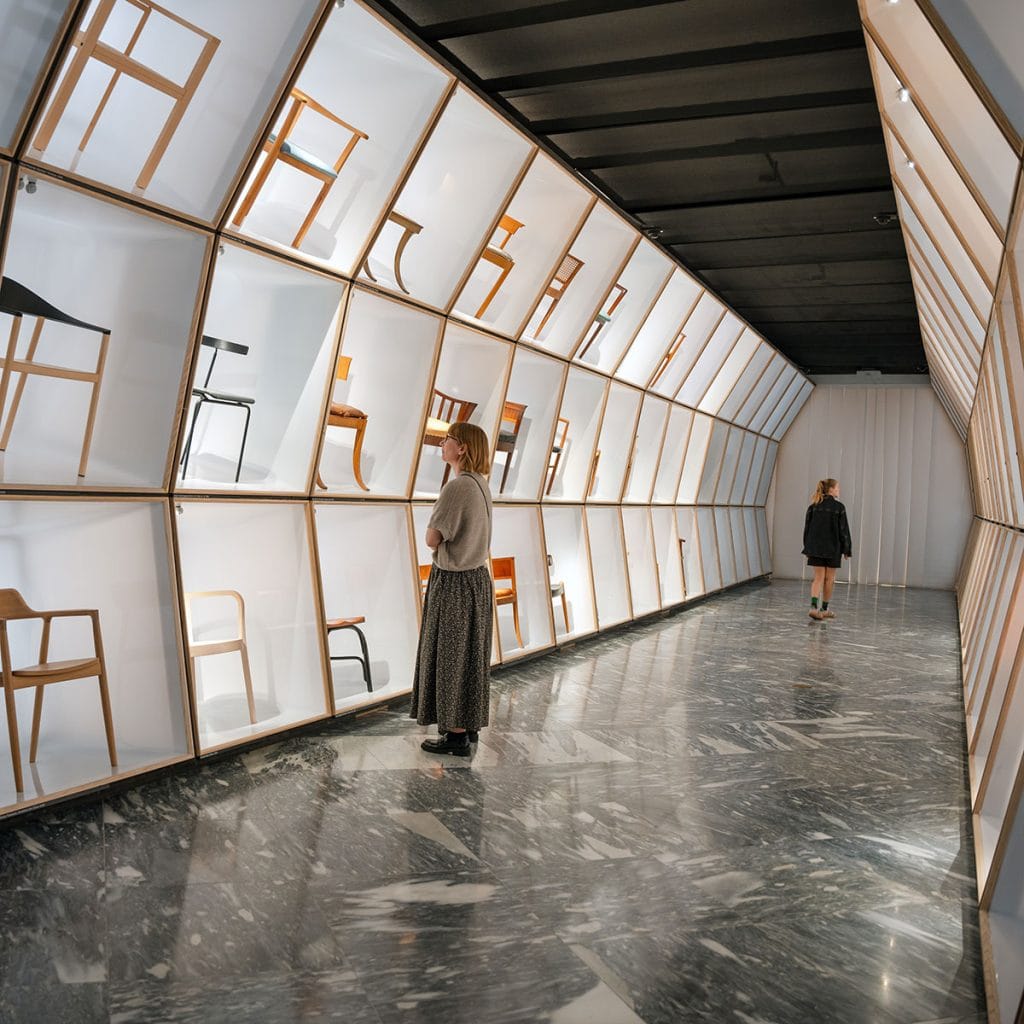 Danish chairs in lit cases in the museum's Danish Modern gallery