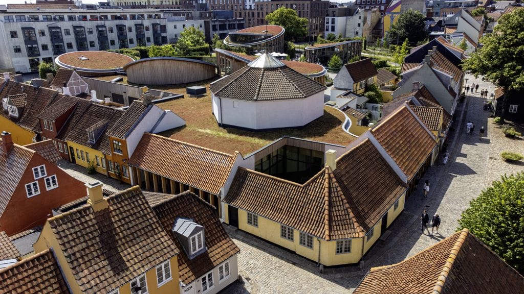 The yellow birthplace and the museum's round green-roofed pavilions from above