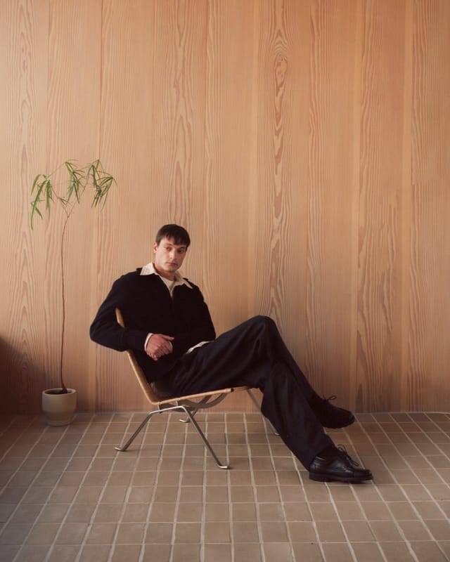 A black knitted jacket and wool trousers