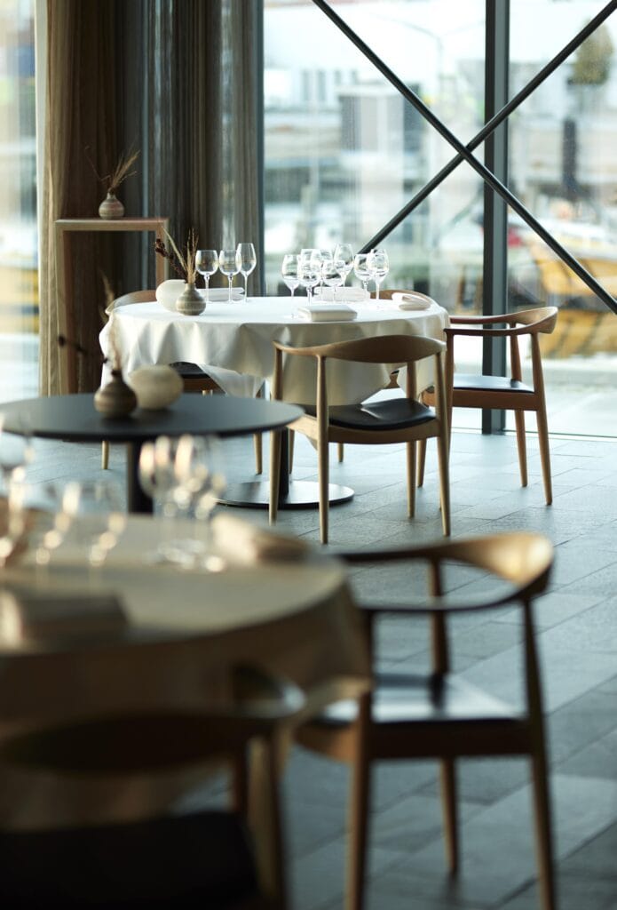 Tables laid by the harbour windows
