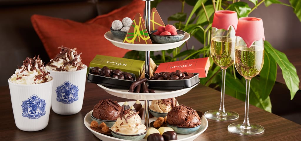 Filled chocolates, truffles and boxes on a tiered stand