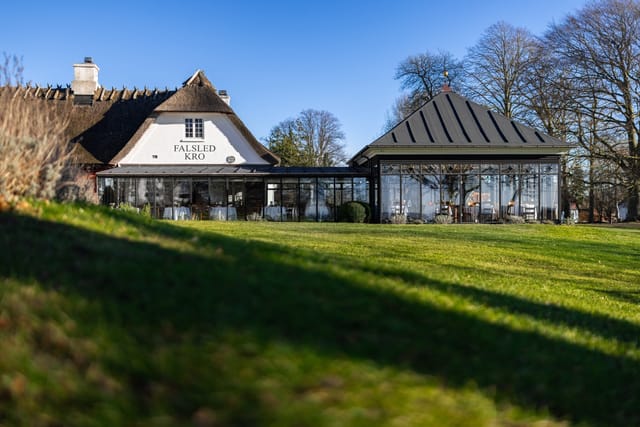 The thatched inn and its glass pavilion from the garden