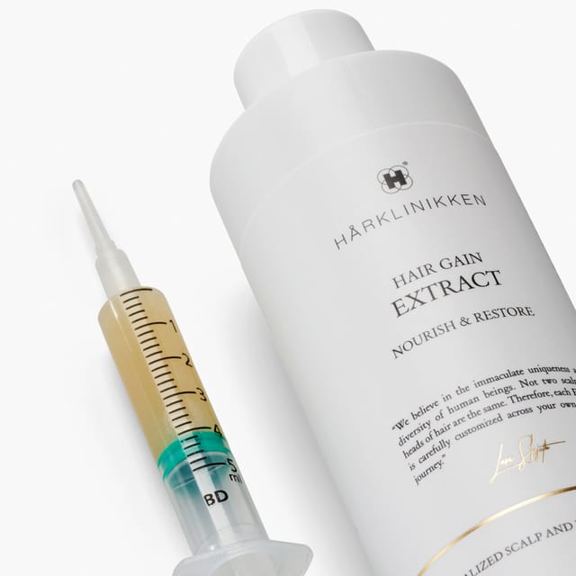 Hair Gain Extract with a dosing syringe of the serum