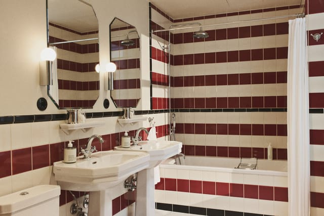 A bathroom tiled in red and white