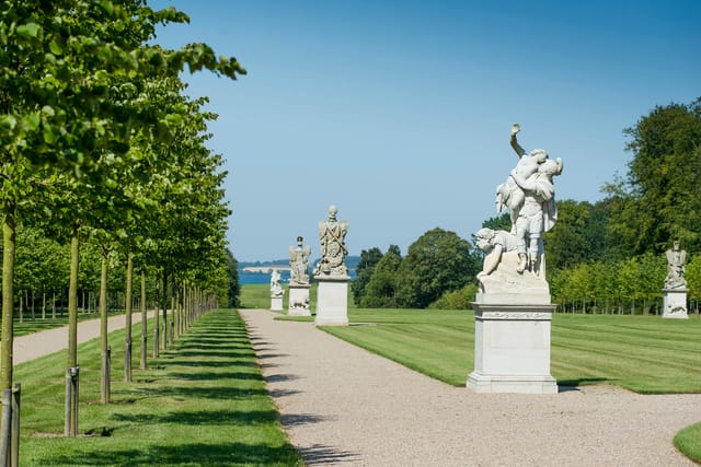 Sculptures along Brede Allé, with Lake Esrum behind