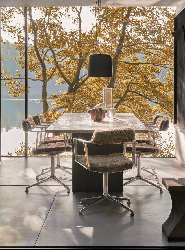 The dining area behind the floor-to-ceiling glass
