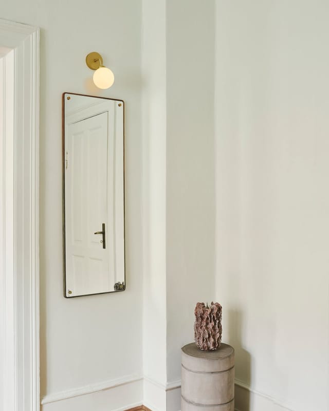 Apiales wall lamp beside a mirror