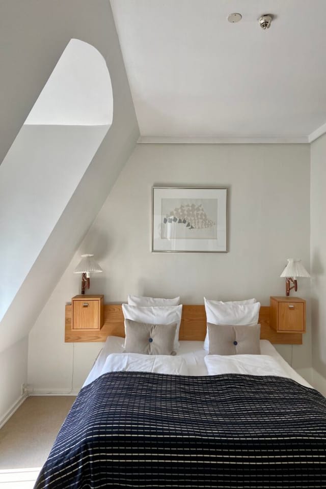 A bedroom under the roof in the Collector's Suite