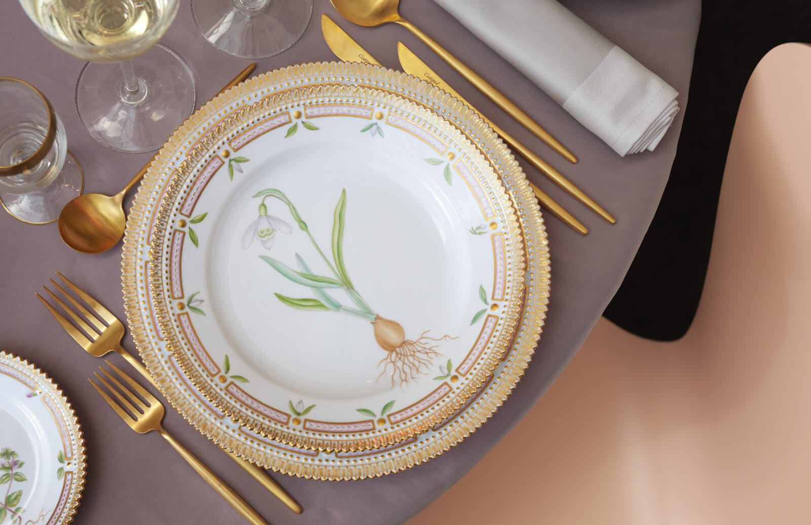 A Flora Danica plate painted with a snowdrop