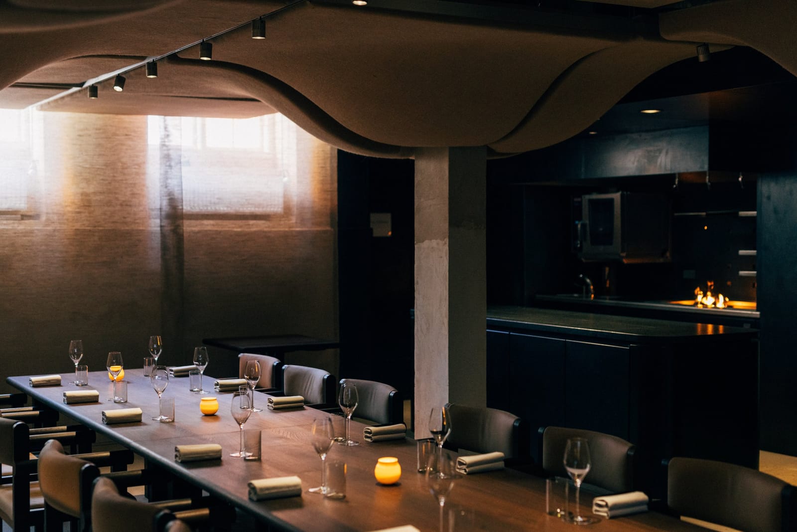 The private dining room, laid for dinner, with its open kitchen