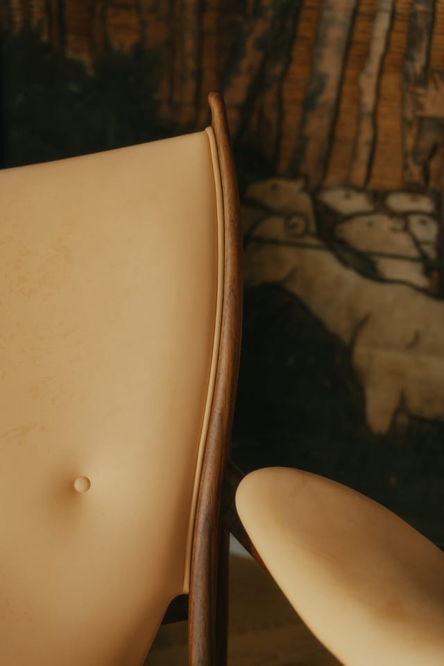The back and armrest of a Chieftain Chair in walnut