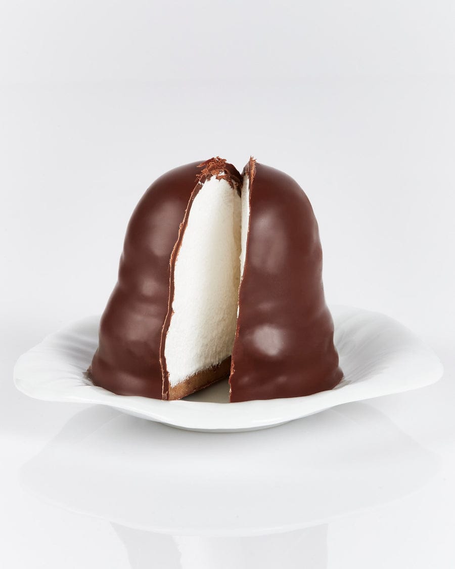 A Grand Cru flødebolle cut open: marzipan base, vanilla foam, dark chocolate