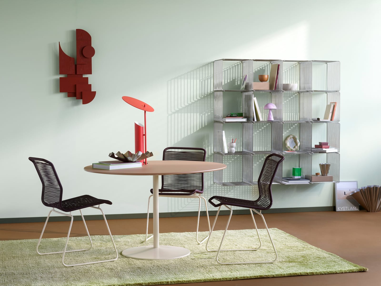 Three Panton One dining chairs with dark cord around a round table