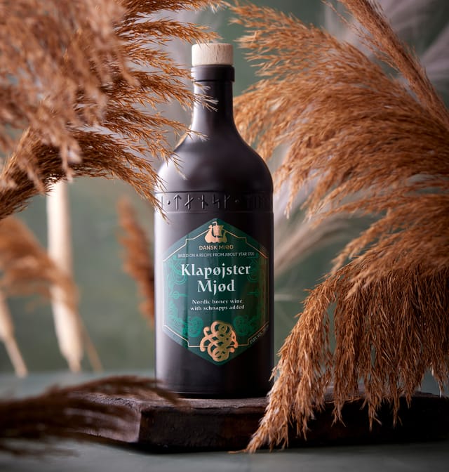 A bottle of Klapøjster Mjød among dried grasses
