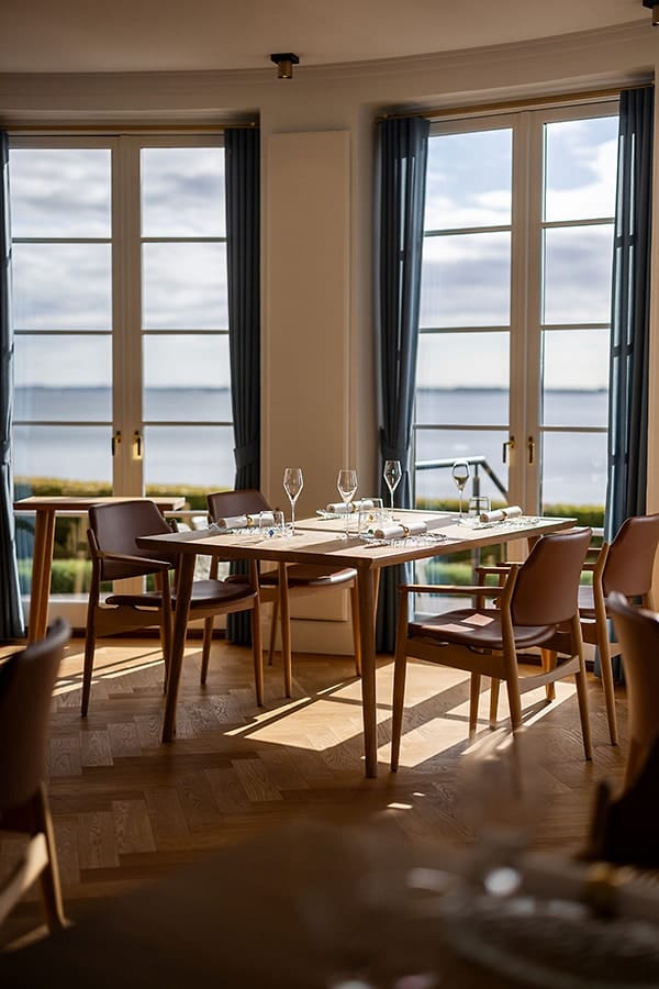 A table by the windows over Flensburg Fjord