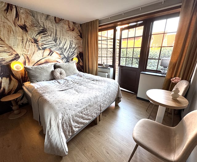 The Jungle room, with its palm mural and garden door