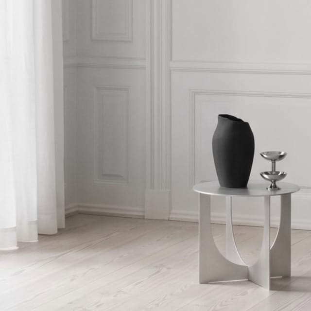 The table with a vase in a panelled room