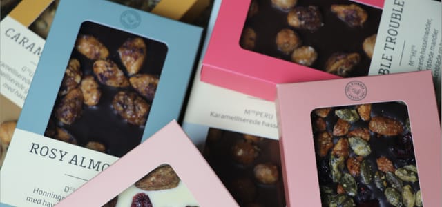 Chocolate bars with caramelised nuts in their boxes