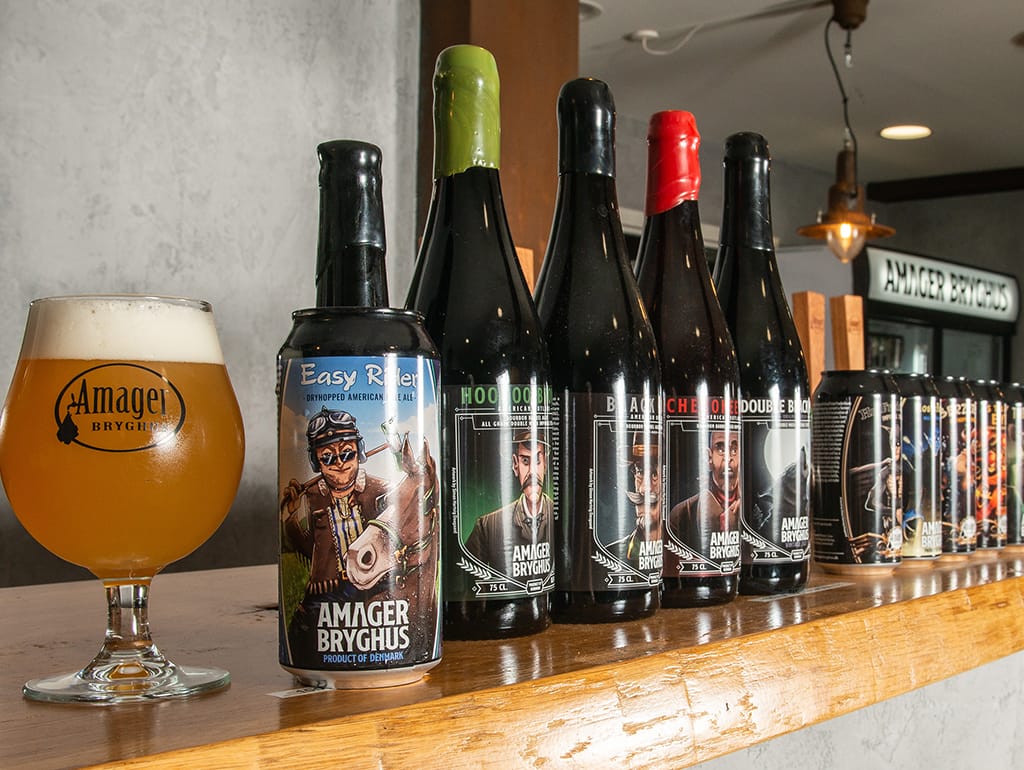 Amager Bryghus cans and bottles on the bar at the brewery