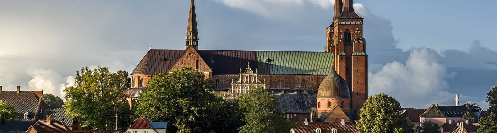 The cathedral's brick nave and twin spires above Roskilde
