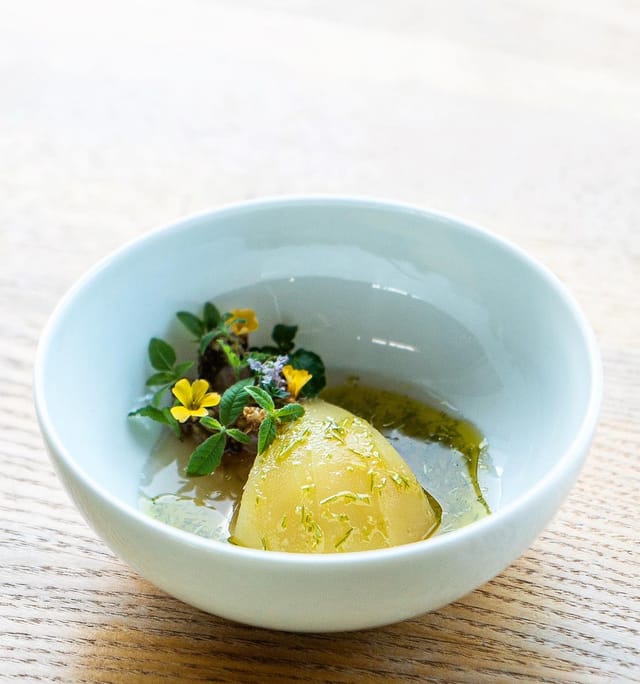 Poached pear with herbs and flowers