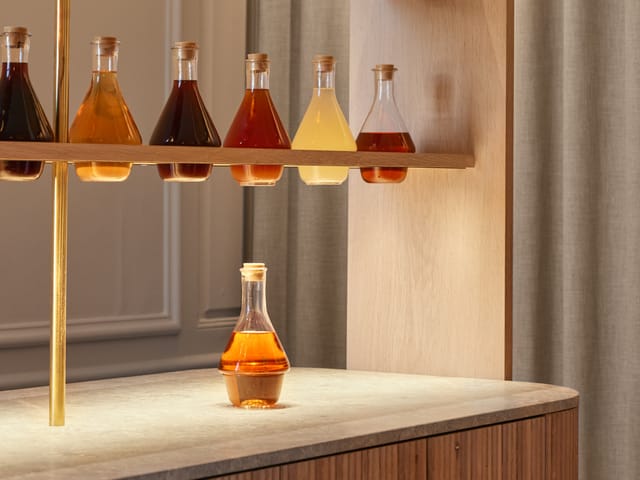 Glass flasks of extract on a shelf at the clinic