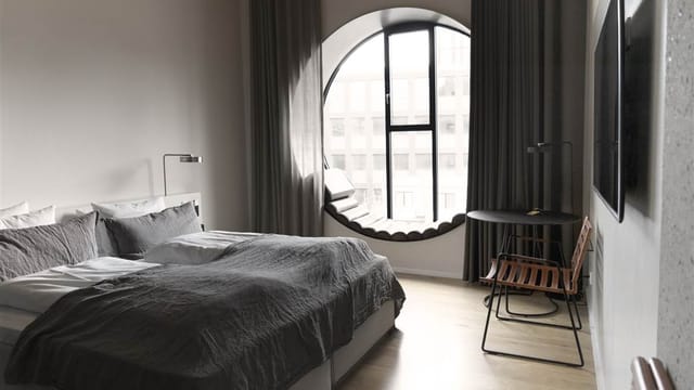 A deluxe room with a round window seat
