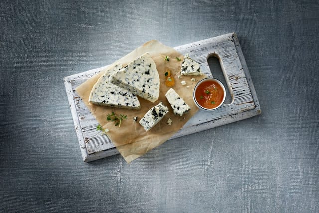 Danish Blue cheese cut on a board