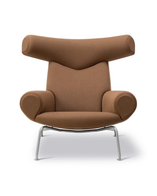 The Ox Chair in fabric with leather piping on a brushed steel frame