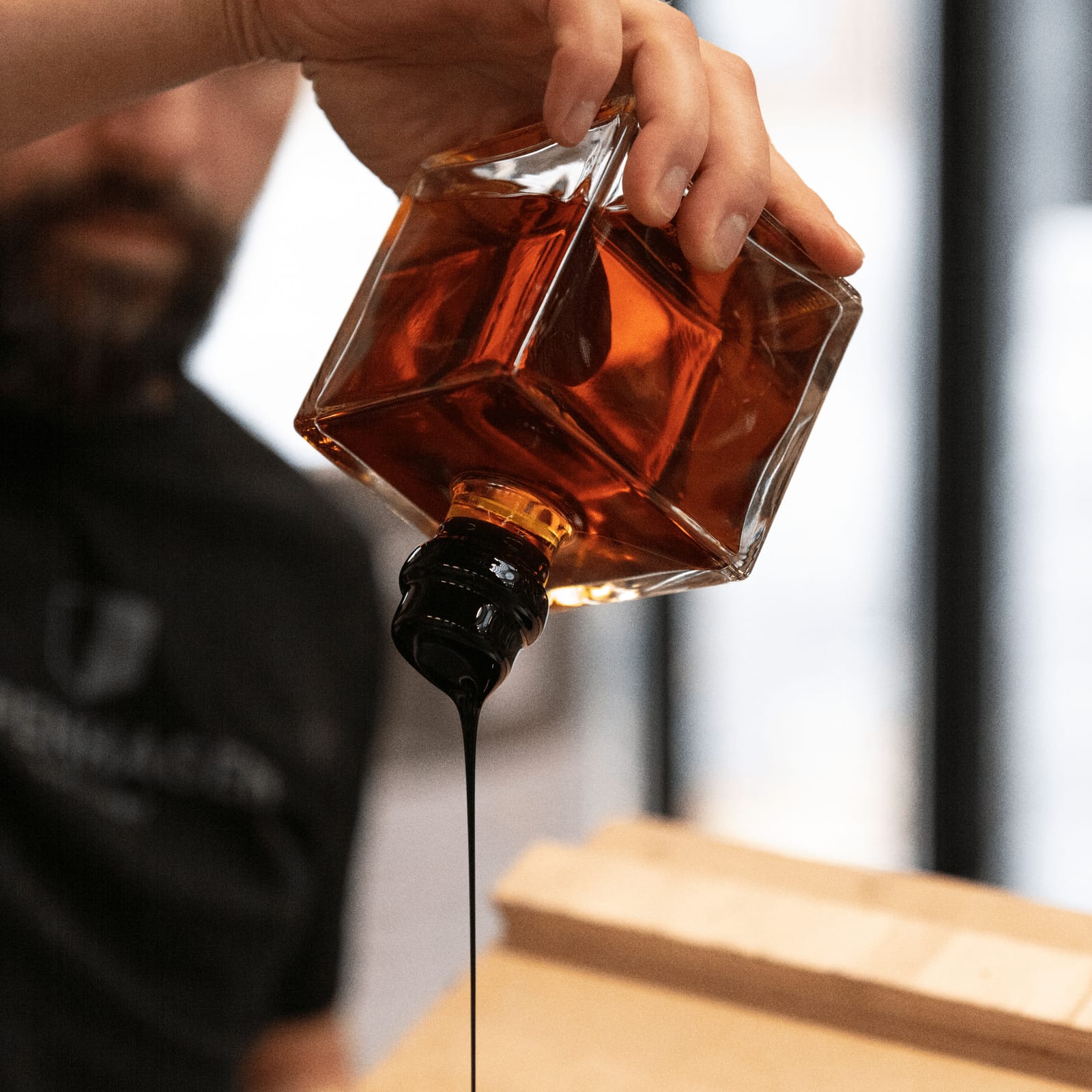 A bottle of Raw being sealed in wax by hand