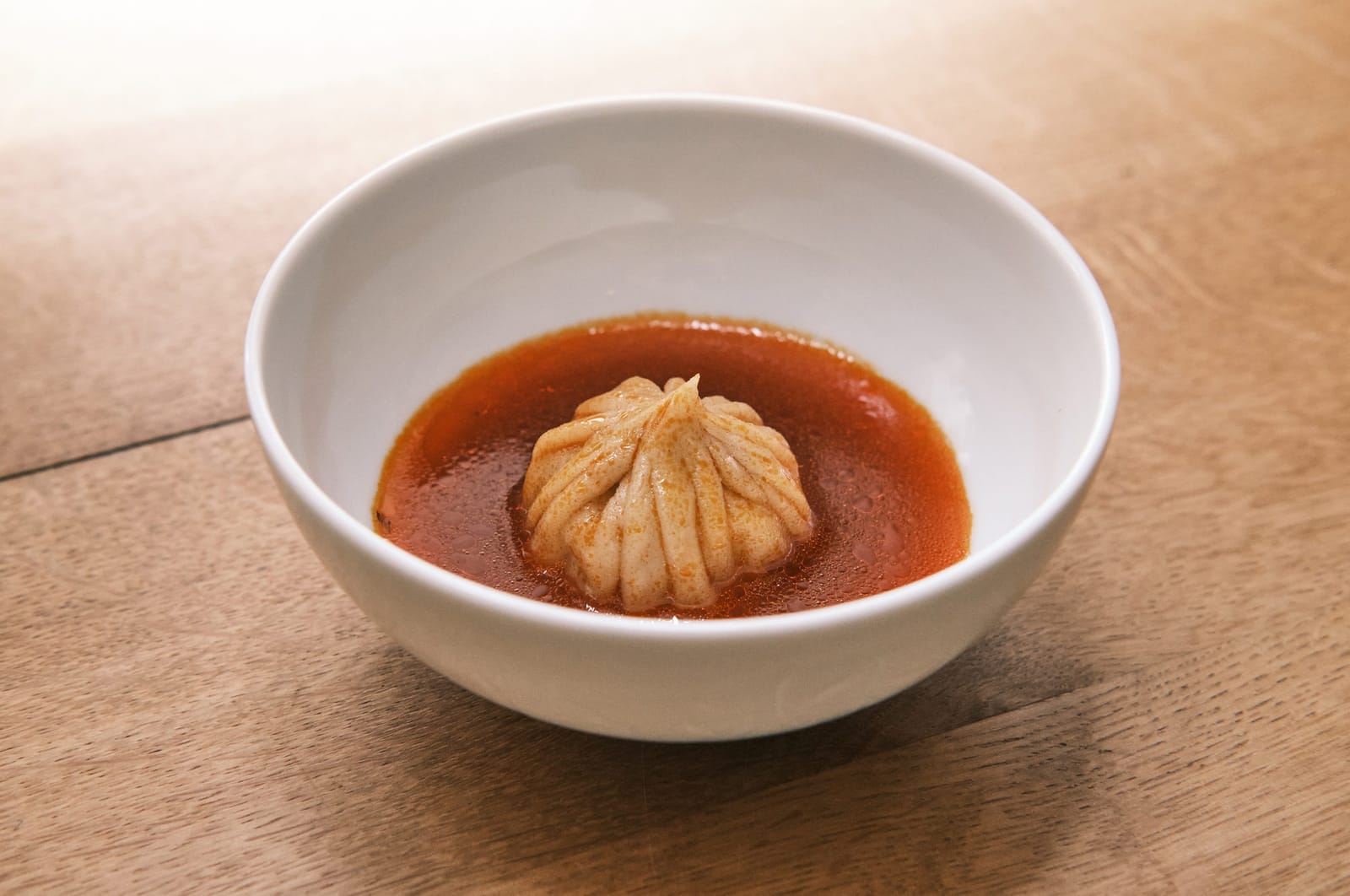 A dumpling in red broth