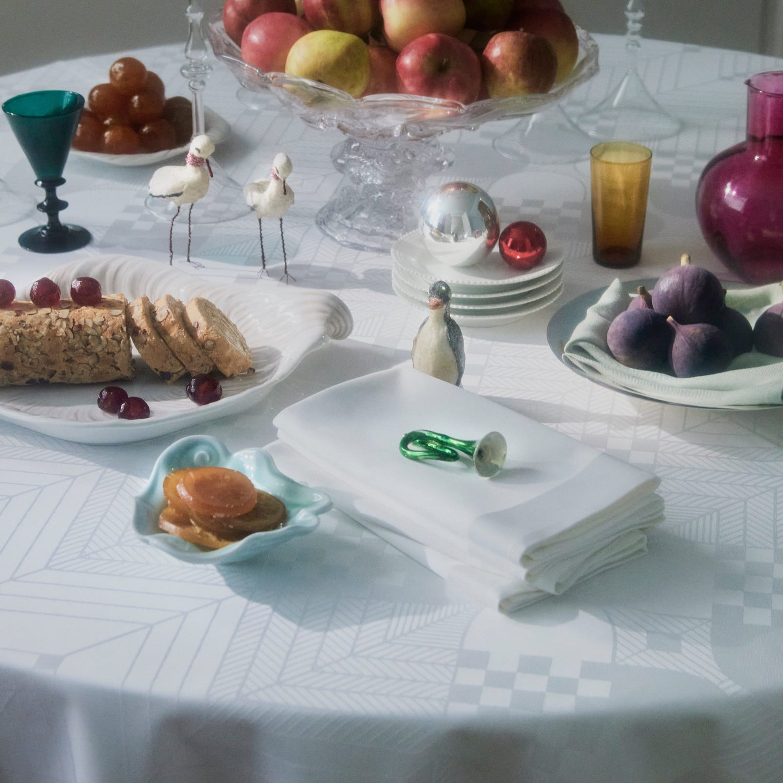 Christmas tablecloth in white on a laid table