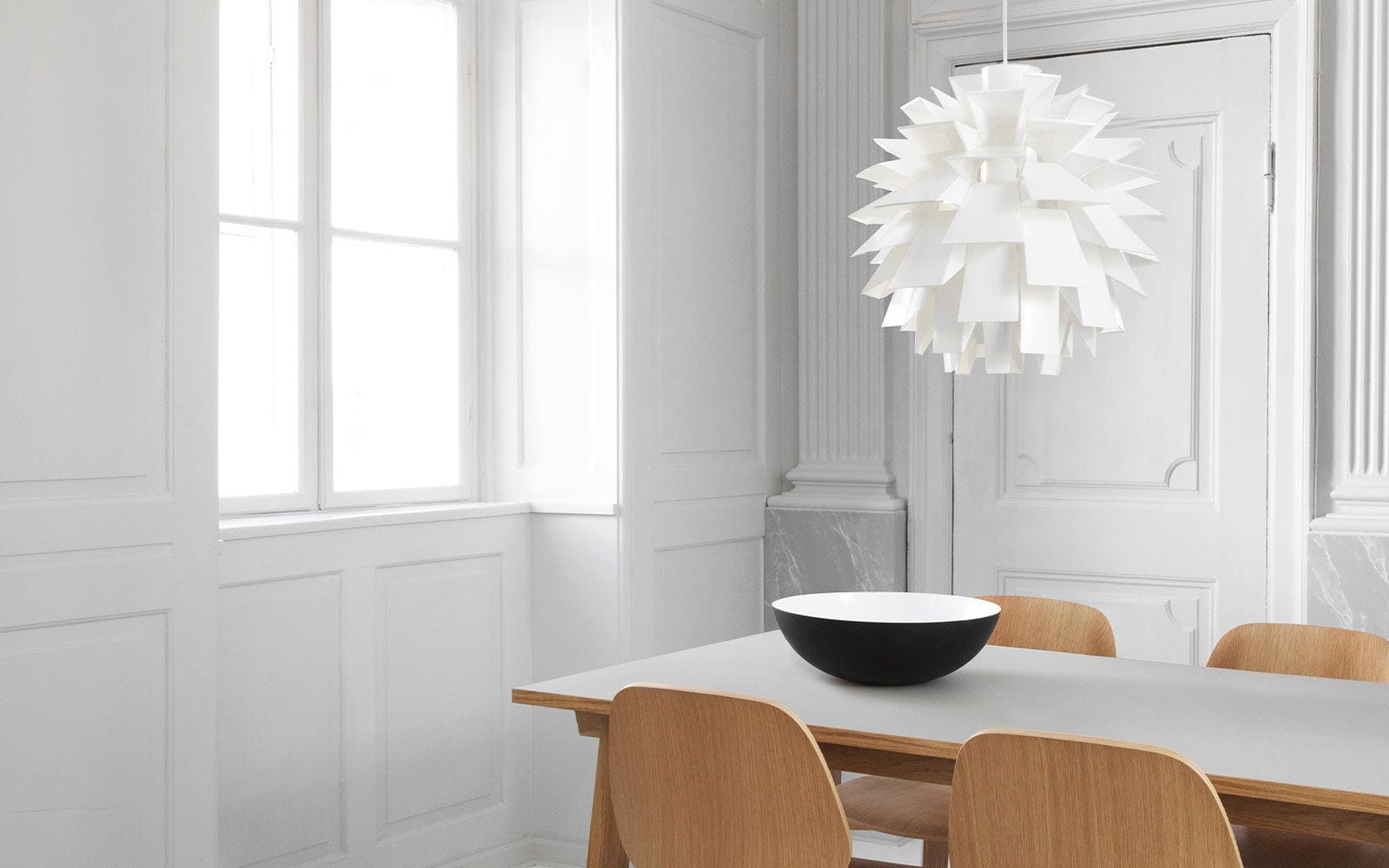 A white Norm 69 over a dining table