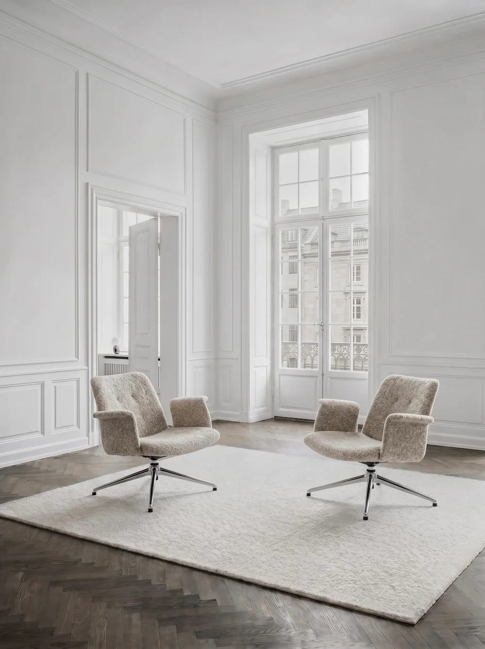 Two Primum lounge chairs on polished bases