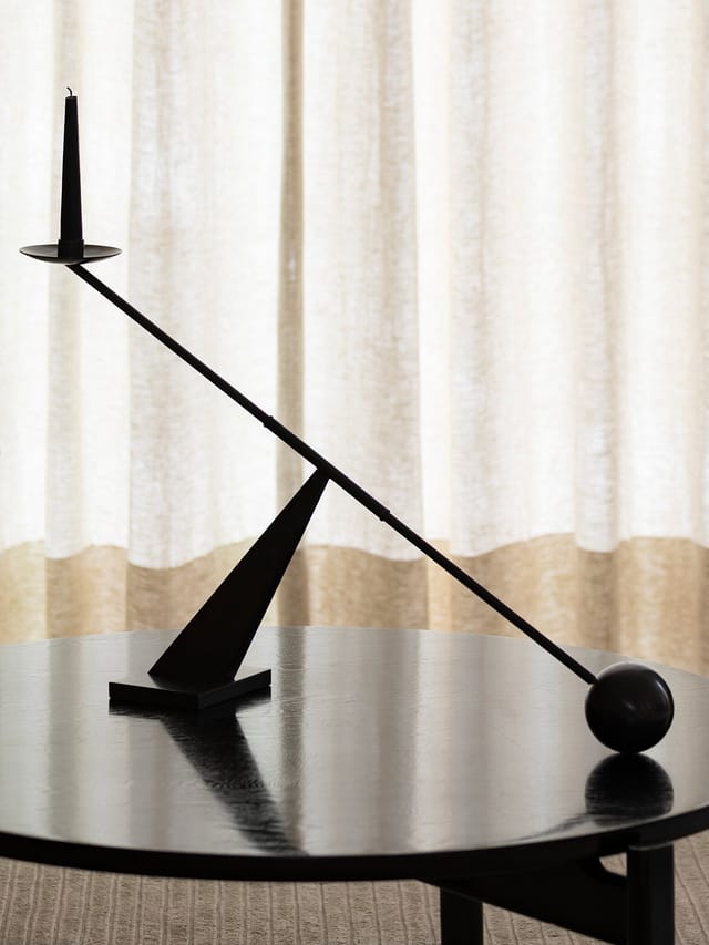The black Interconnect candleholder on a round table
