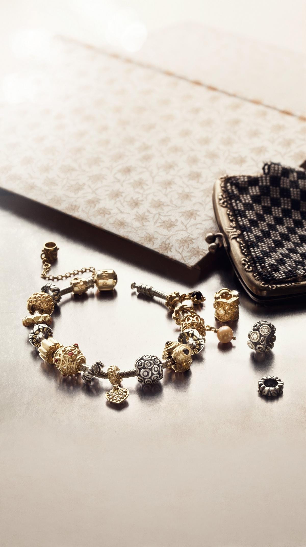 A charm bracelet in silver and gold
