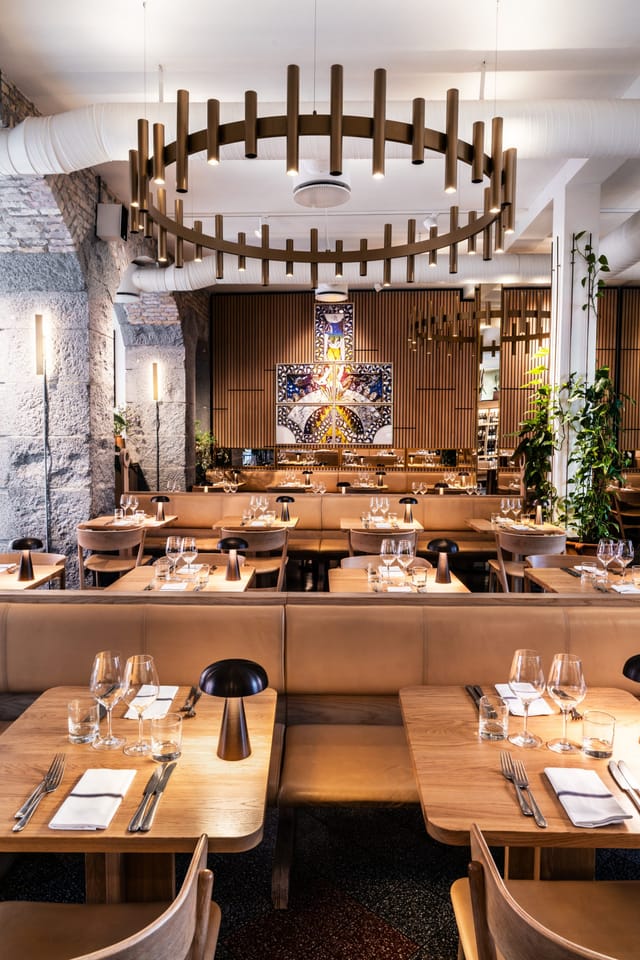 The dining room under its ring chandeliers